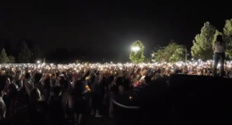 Hundreds of people hold up candles at knight in Marketplace park to honor Charlie Kirk.