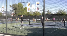 A fence at the Pasco Club in Santa Clarita with images of children that receives help from cancer funding.