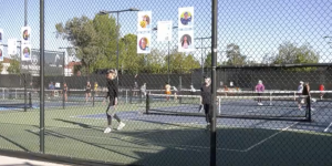 A fence at the Pasco Club in Santa Clarita with images of children that receives help from cancer funding.