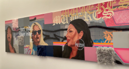 A colorful mural featuring portraits of three women against a backdrop of graffiti-style art and text. The piece includes bold pink, gray, and blue tones with textured fabric squares attached to the surface. One woman wears large hoop earrings that read “Lady Lowrider,” and the background includes stylized lettering and the phrase “her ride.”